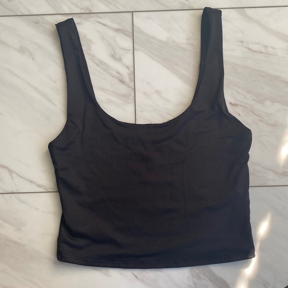 A black muscle crop top by Gaze. Size small.